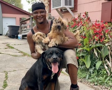 Smiling man with three dogs