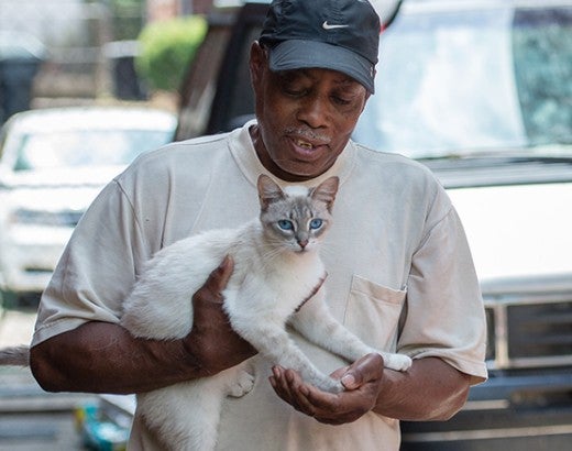 Man holding his white cat