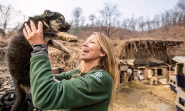 Lola Webber, Campaign Manager for South Korea of HSI, holds Moon Bears' puppy at a dog meat farm in Siheung, South Korea.