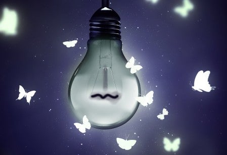 Photo illustration of a dim light bulb with illustrated butterflies