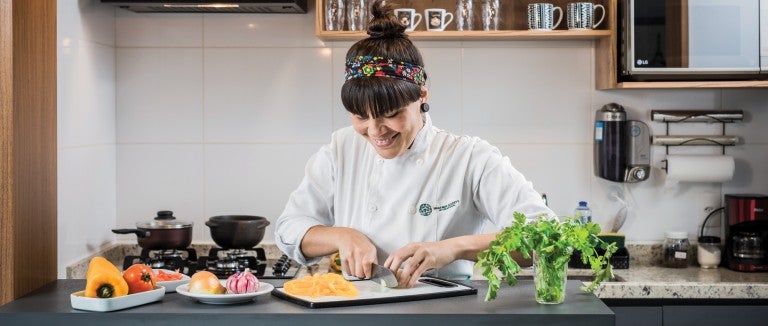 Chef Adriele Carvalho prepares ingredients for her plant-based take on a Brazilian stew.