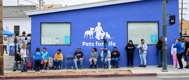 People waiting in line outside for Pets For Life services.